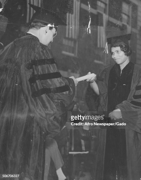Howard University president Mordecai Wyatt Johnson presents singer Marian Anderson with an honorary degree at Howard University, Washington DC, June...