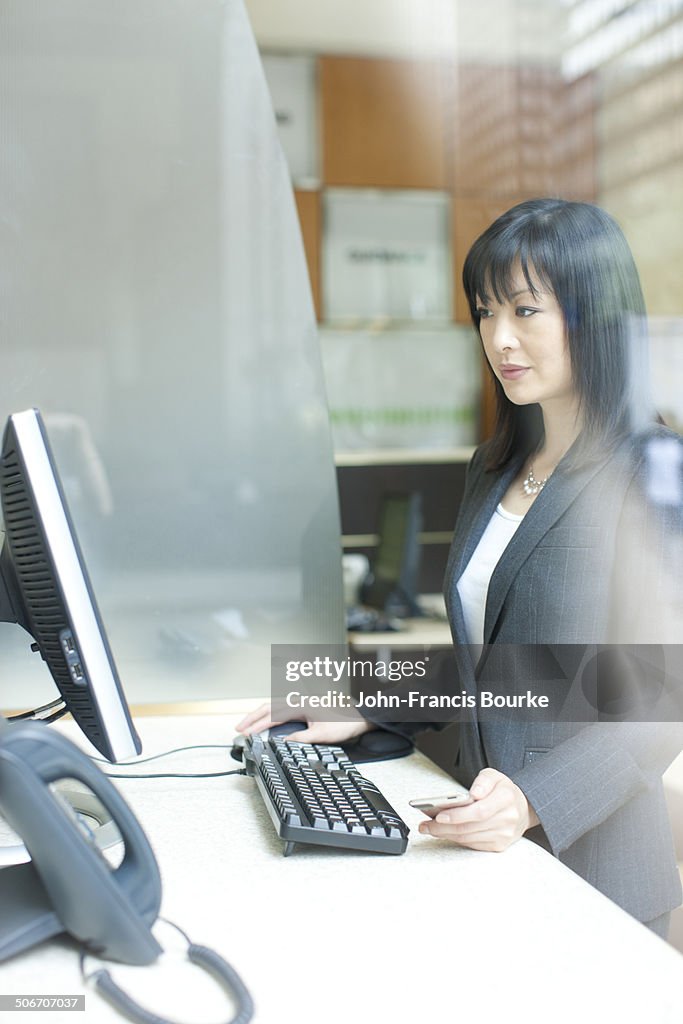 Asian business woman at her computer