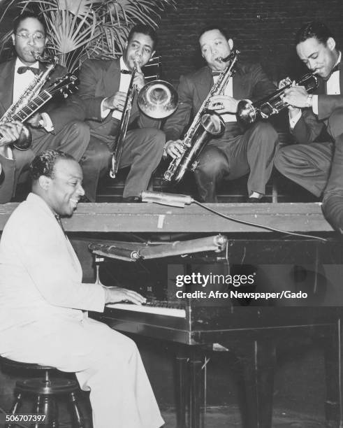 African-American jazz musician Count Basie and a Jazz orchestra playing the piano, 1945.