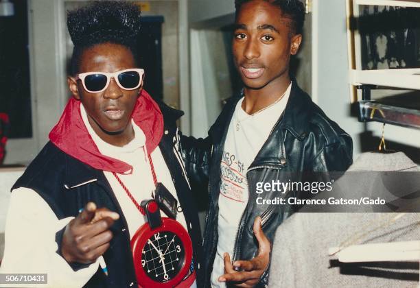 Flavor Flav, standing with rapper Tupac Shakur, greets fans backstage during the 1989 American Music Awards, Los Angeles, California, January 30,...