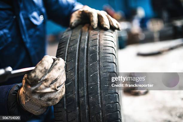 car tire repairmen with caliber - tyre stock pictures, royalty-free photos & images