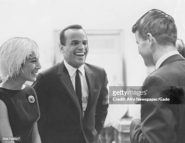 Musician and actor Harry Belafonte, Julie Belafonte and former Senator and Attorney General Robert Kennedy laughing, April 14, 1962.