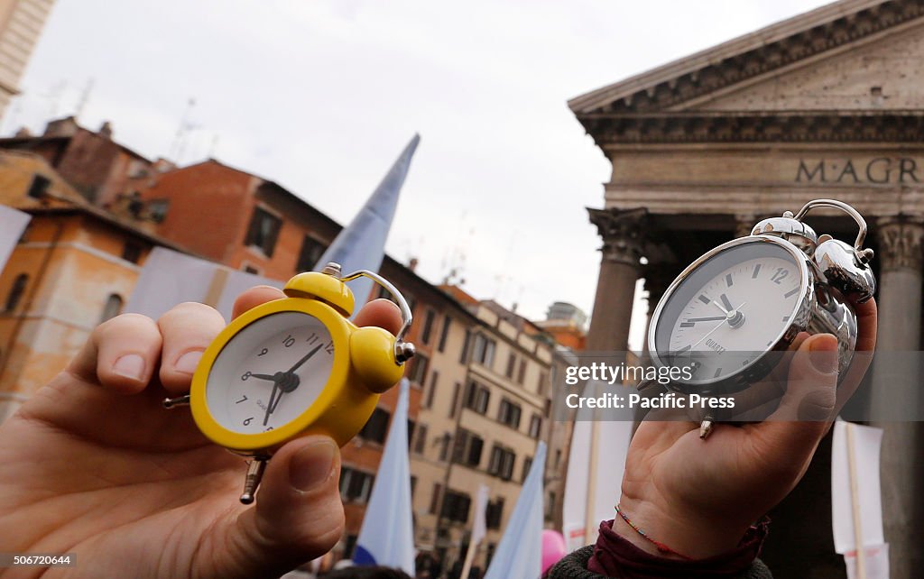 Protesters hold alarm clocks during demonstration in favor...