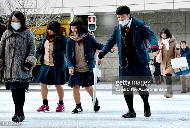 High school students walk on the frozen street in front of the Nagoya Station on January 25, 2016 in Nagoya, Aichi, Japan. Low temperatures also set...