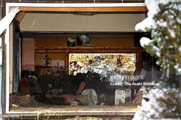 Destroyed house after the snowstorm triggered a landslide killing a 88-year-old woman is seen on January 25, 2016 in Nichinan, Tottori, Japan. Low...