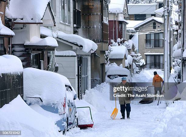 People remove snow on the street on January 25, 2016 in Wajima, Ishikawa, Japan. Low temperatures also set a record at many observatories around...