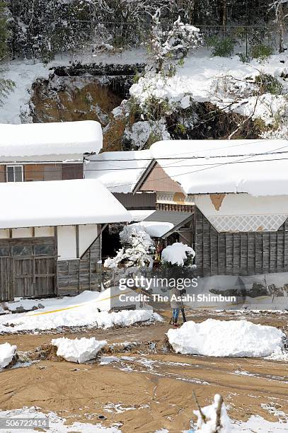 Destroyed house after the snowstorm triggered a landslide killing a 88-year-old woman is seen on January 25, 2016 in Nichinan, Tottori, Japan. Low...