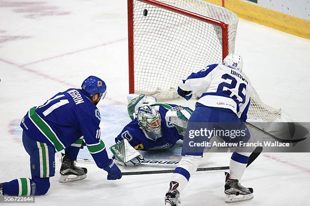 Toronto Marlies Connor Brown scores his second goal of the game past Utica Comets goalie Richard Bachman and defensemen John Negrin during first...