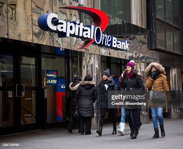 Pedestrians walk past a Capital One Financial Corp. Bank branch in New York, U.S., on Friday, Jan. 22, 2016. Capital One Financial Corp. Is scheduled...