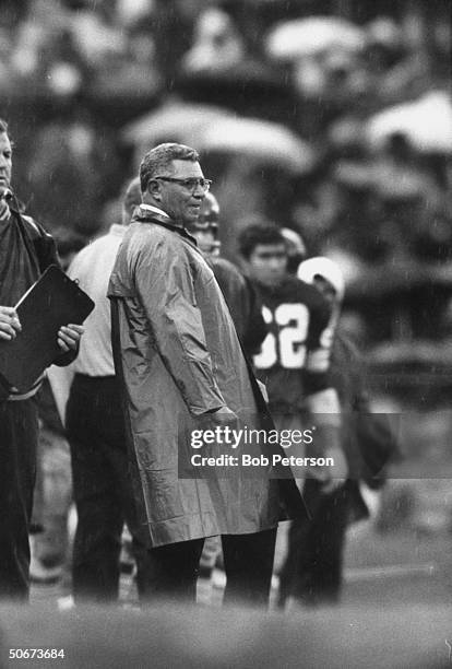 Redskins Coach, Vince Lombardi, standing on sidelines as light rain falls, during game with Cleveland Browns, at R. F. K. Memorial Stadium.