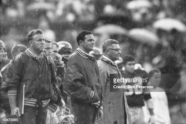 Redskins Coach, Vince Lombardi, standing on sidelines as light rain falls, during game with Cleveland Browns, at R. F. K. Memorial Stadium.