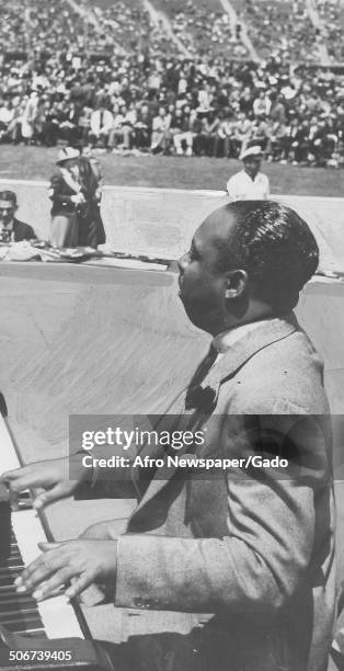 African-American jazz musician Count Basie playing the piano during the Great Carnival of Swing, Randalls Island, New York, 1938.