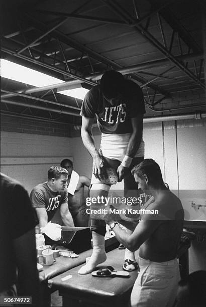 New York Jets quarterback Joe Namath getting his knees bandaged after a game against the Houston Oilers.