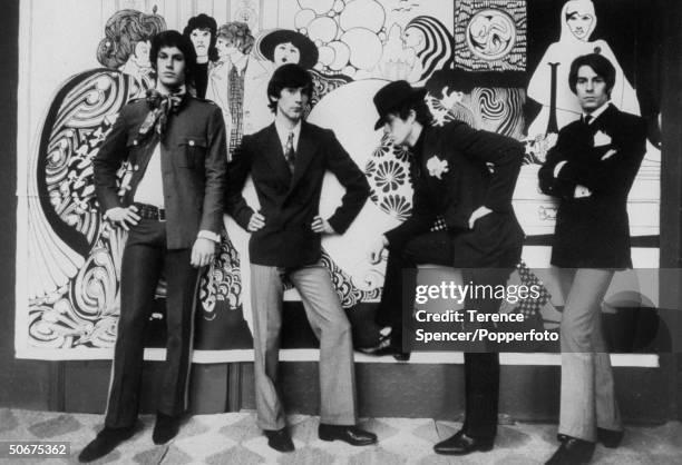 Male fashion models and designers, including fashion entrepreneur Neil Winterbotham on right and designer Ossie Clark , 2nd from left, posing in...