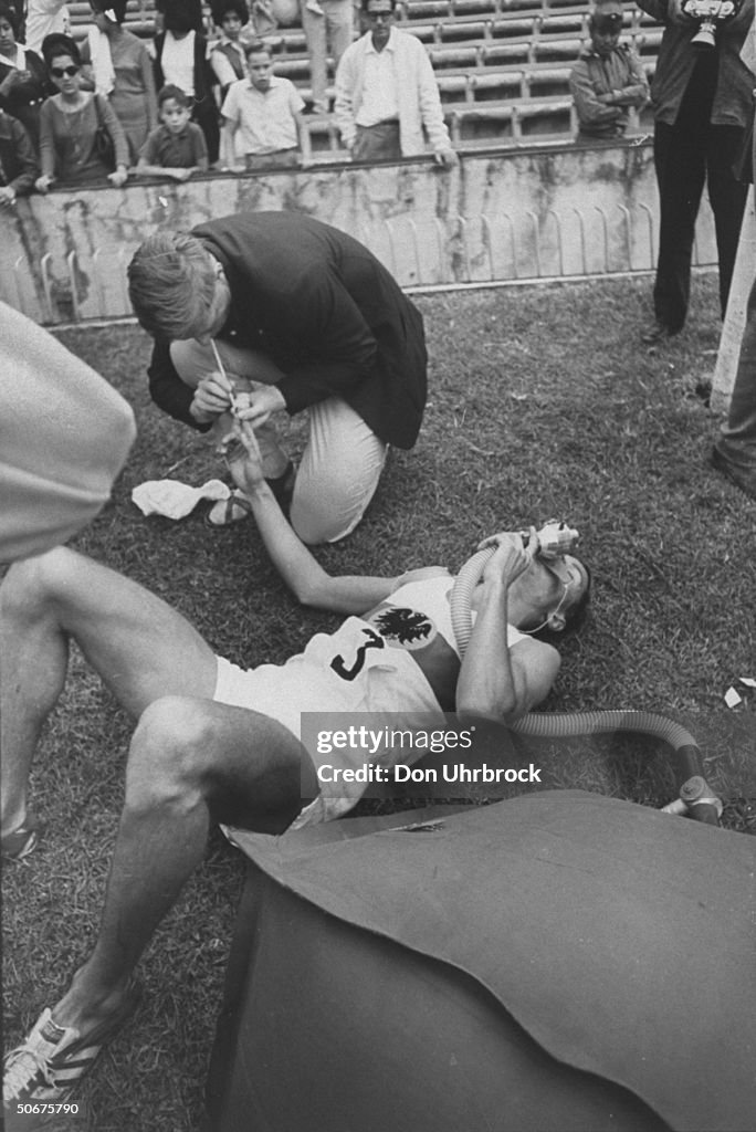 An athlete is getting oxygen at track ev