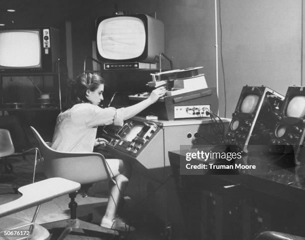Graduate student at the University of Pennsylvania's Annenberg School of Communications working with videotape equipment.