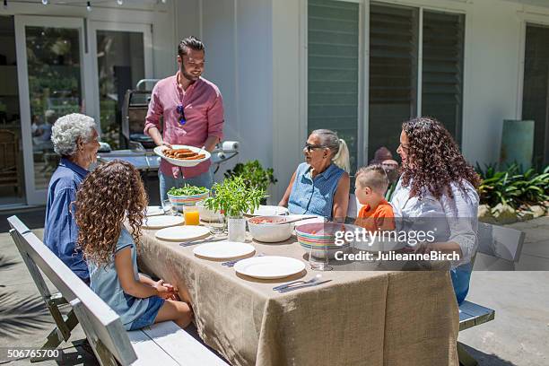 barbecue lunch with all the family - australian bbq stock pictures, royalty-free photos & images