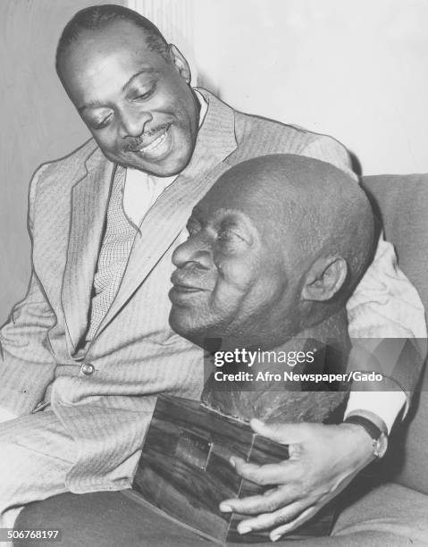 African-American jazz musician Count Basie, with a bust of Count Basie, November 9, 1957.