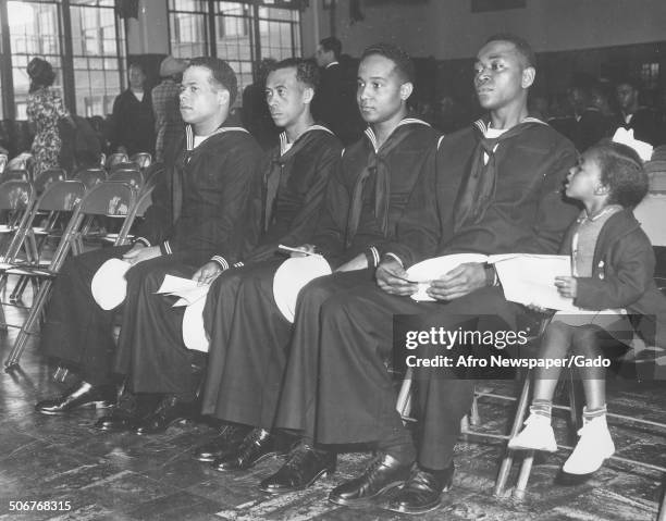 African-American United States Navy seamen and a girl at the United States Naval Academy during a graduation ceremony, Annapolis, Maryland, 1944.