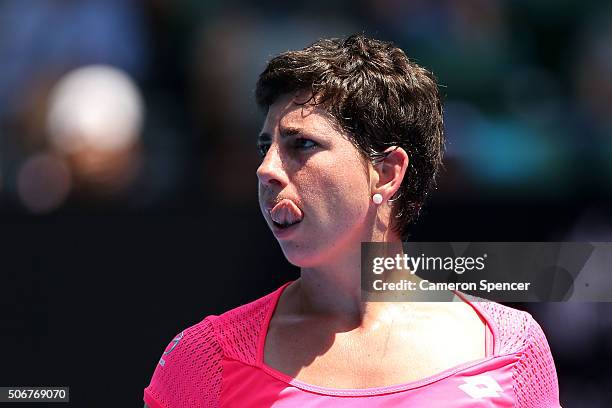 Carla Suarez Navarro of Spain sticks her tongue out in her quarter final match against Agnieszka Radwanska of Poland during day nine of the 2016...