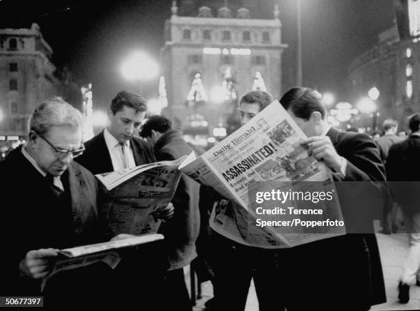 People reading the newspaper in Piccadilly Circle, after John F. Kennedy's assassination.