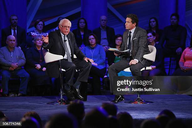 Democratic presidential candidate Senator Bernie Sanders speaks at a town hall forum hosted by CNN as moderator Chris Cuomo looks on at Drake...