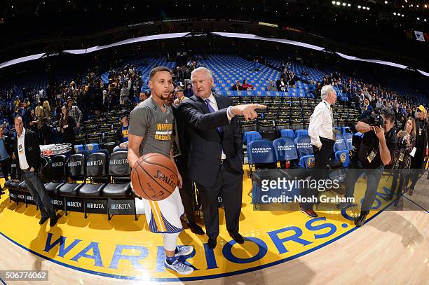 Stephen Curry of the Golden State Warriors chats with Executive board member Jerry West on January 25, 2016 at Oracle Arena in Oakland, California....