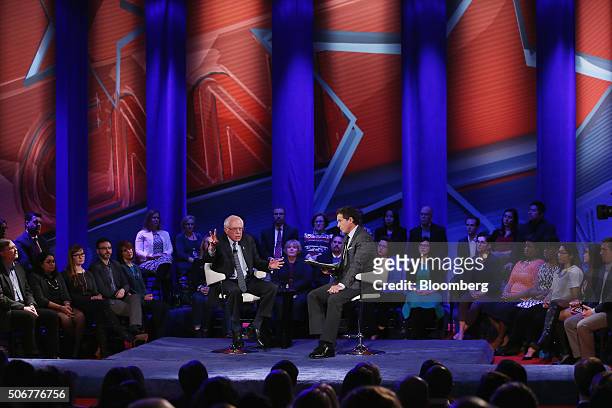 Senator Bernie Sanders, an independent from Vermont and 2016 Democratic presidential candidate, center left, gestures as he speaks with moderator...