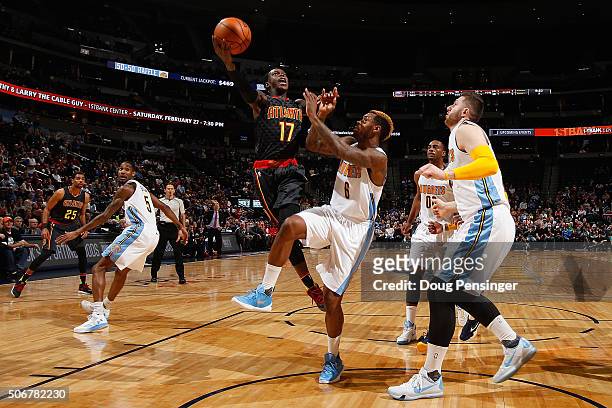 Dennis Schroder of the Atlanta Hawks lays up a shot against Sean Kilpatrick of the Denver Nuggets as Jusuf Nurkic, Darrell Arthur and Will Barton of...