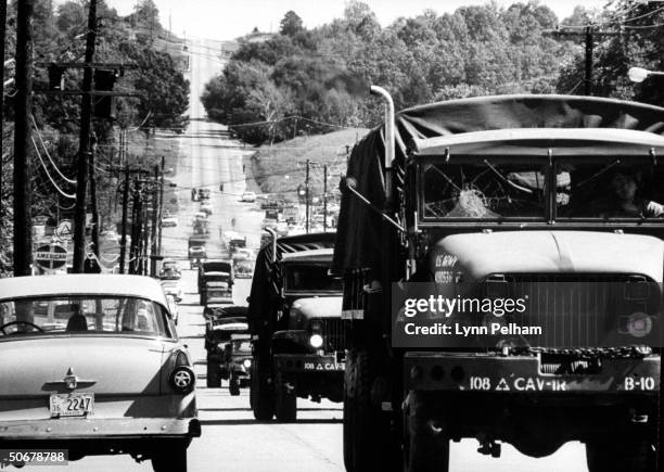 Troops patroling streets during riots vs enrollment of African American, James H. Meredith, at Univ. Of Mississippi.