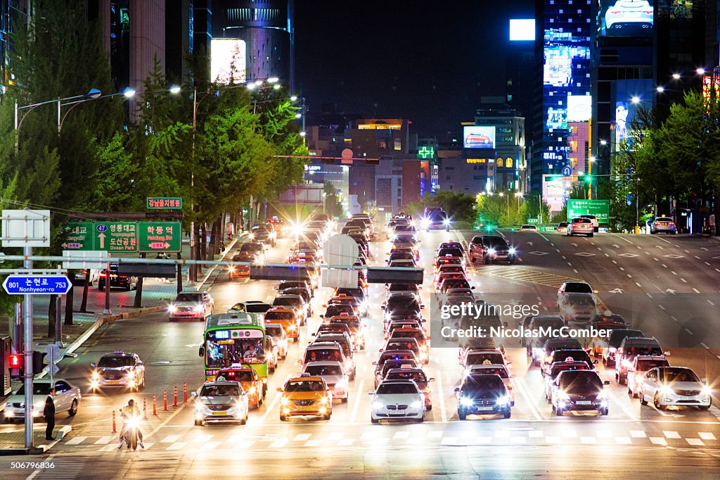 Rows of cars waiting for traffic light at night