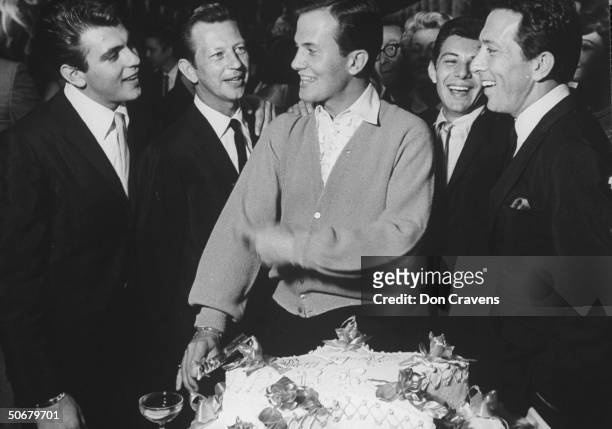 Fabian Forte , Donald O'Connor , Frankie Avalon , Andy Williams , and Pat Boone cutting his birthday cake during party at the Ambassador Hotel.