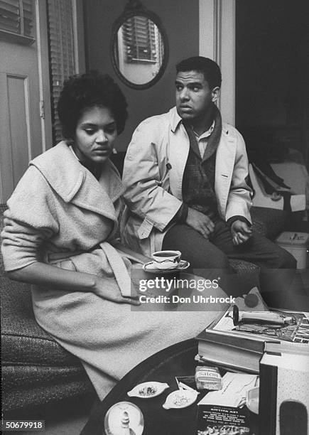 African American students Charlayne Hunter and Hamilton Holmes , talking after being escorted by state troopers from the University of Georgia.