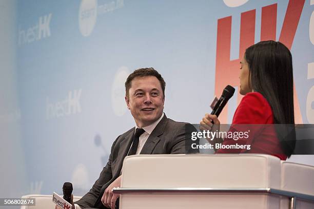 Billionaire Elon Musk, chief executive officer of Tesla Motors Inc., left, listens during the StartmeupHK Venture Forum in Hong Kong, China, on...