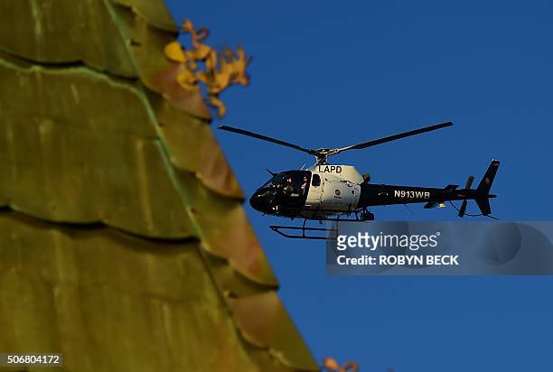 Los Angeles Police Department helicopter flies over the TCL Chinese Theatre in Hollywood, California before the start of the red carpet ceremony for...
