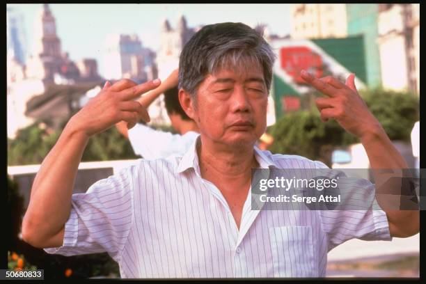 Falun Gong discipline follower performing meditation & exercises.