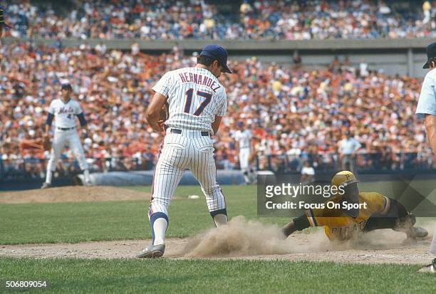 Marvell Wynne of the Pittsburgh Pirates dives back into first base beating the throw over to Keith Hernandez of the New York Mets during an Major...