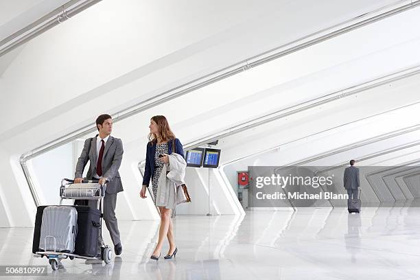 business people with luggage trolley in airport - luggage trolley stock pictures, royalty-free photos & images