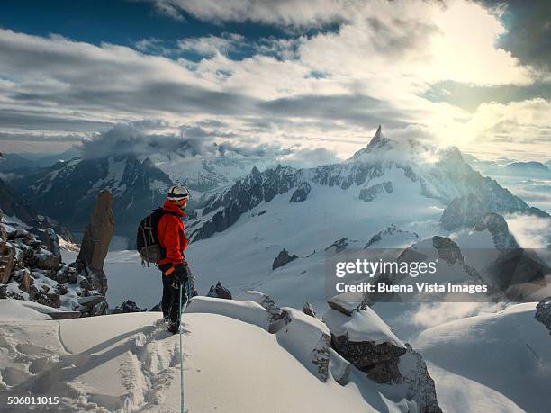 lone climber on the top of a mountain - chamonix winter stock pictures, royalty-free photos & images