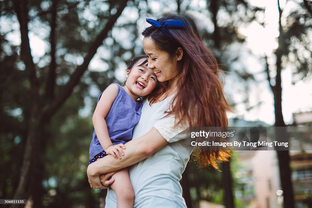 Mom & child talking joyfully in park