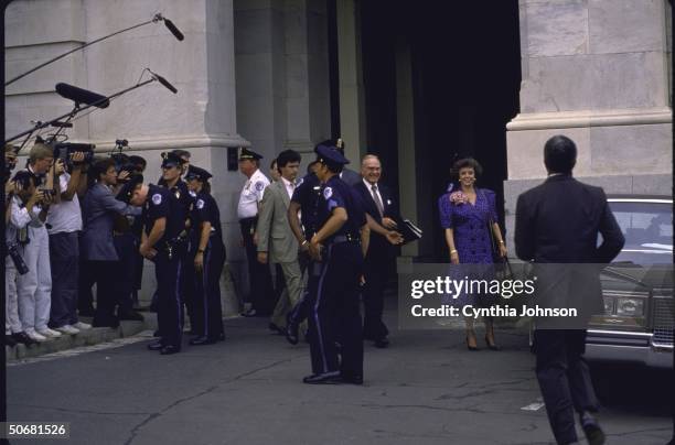 House Speaker James C. Wright Jr., smiling, emerging from Capitol with wife Betty, with waiting crush of photographers and police on hand, re his...