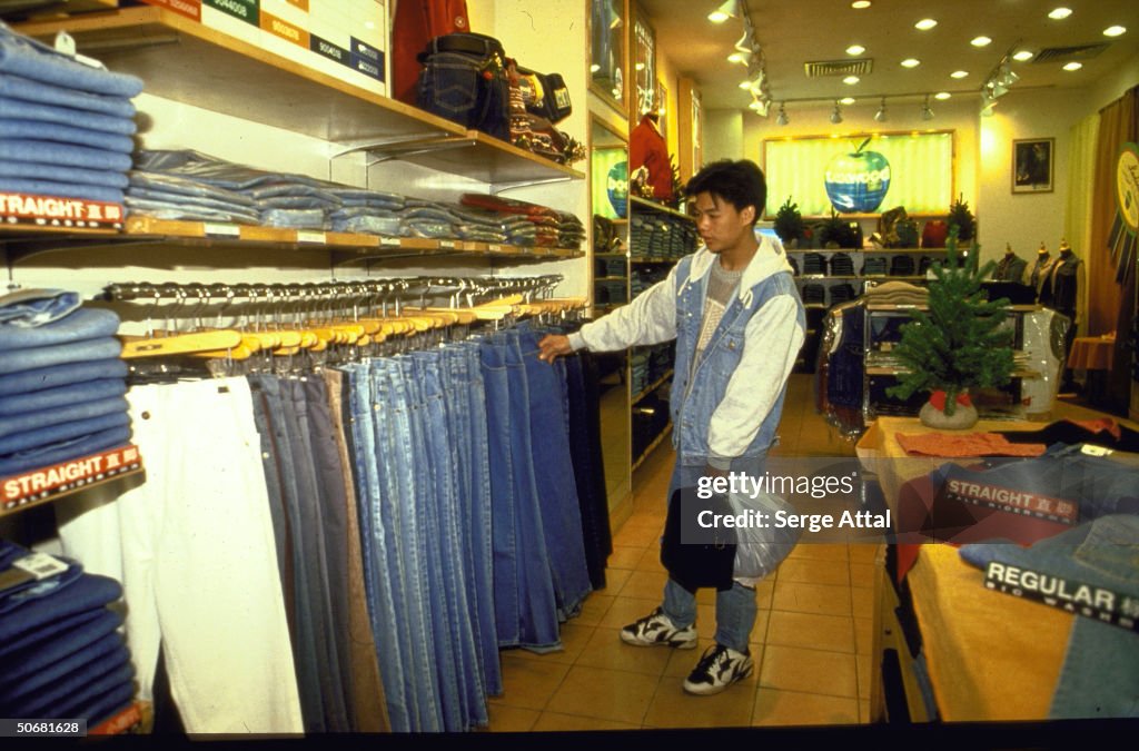 Young man shopping, looking at display o