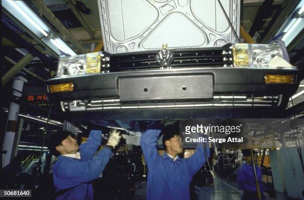 Workers assembling car in Volkswagen plant, 60 km from Shanghai.