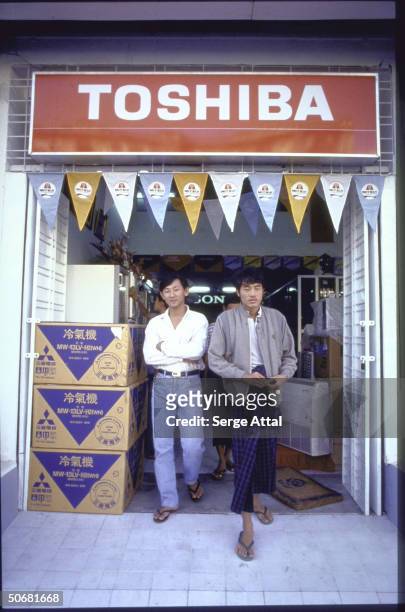 Men walking out of Toshiba store.