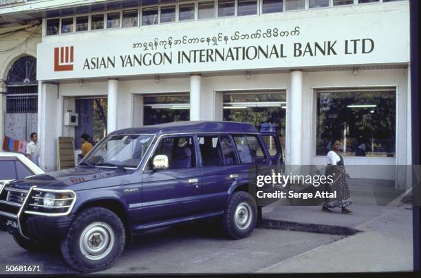 Black Mitsubishi Pajero parked in front of Asian Yangon International Bank.