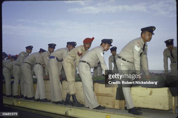 Unidentified people carrying the coffins of victims of a plane crash that also took the life of Pakistani leader Mohammad Zia Ul Haq.