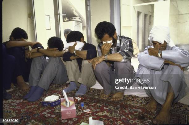 Iranian mourners crying over the dead victims of the Iranian Airbus that was shot down by the USS Vincennes in the Persian Gulf.