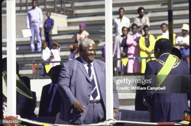 Opposition leader Joshua Nkomo talking with Pres. Robert G. Mugabe during Independence Day celebration at the National Stadium.