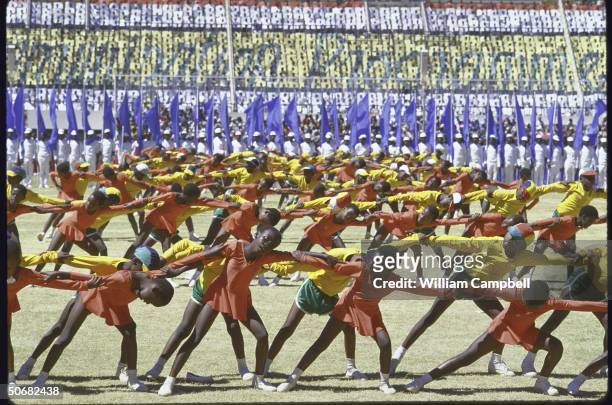 Children in bright uniforms performing during Independence Day celebration at the National Stadium.