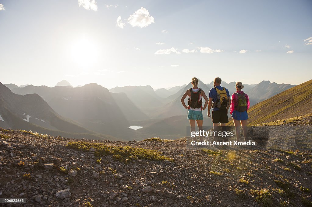 Trail runners relax for moment on mountain ridge